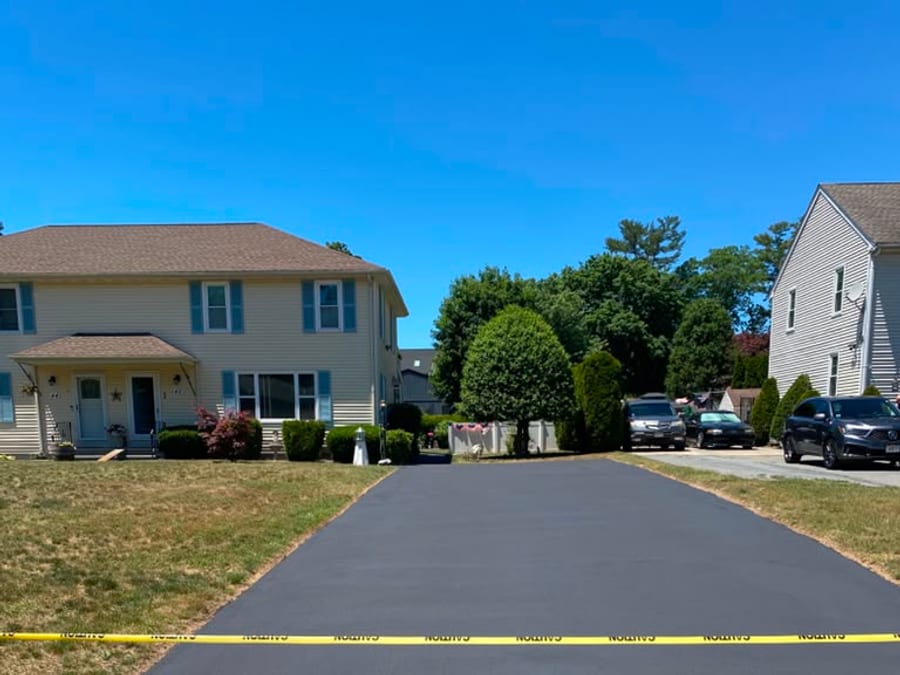 Finished duplex driveway with uniform dark sealcoating