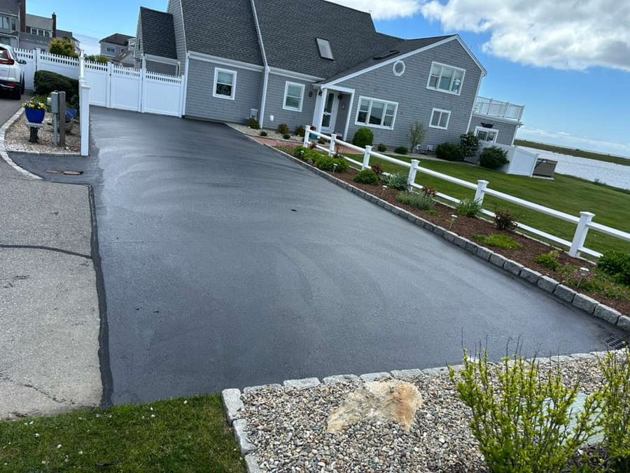 Finished waterfront driveway with clean dark sealcoating